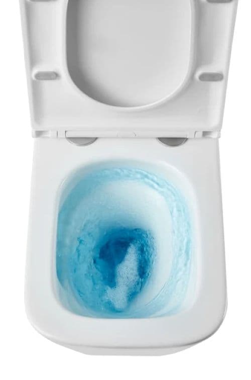 Унітаз під час змиву блакитною водою